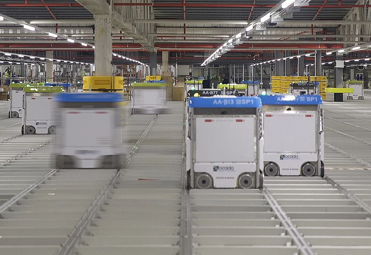 Many Ocado warehouse robots operating simultaneously on a storage grid