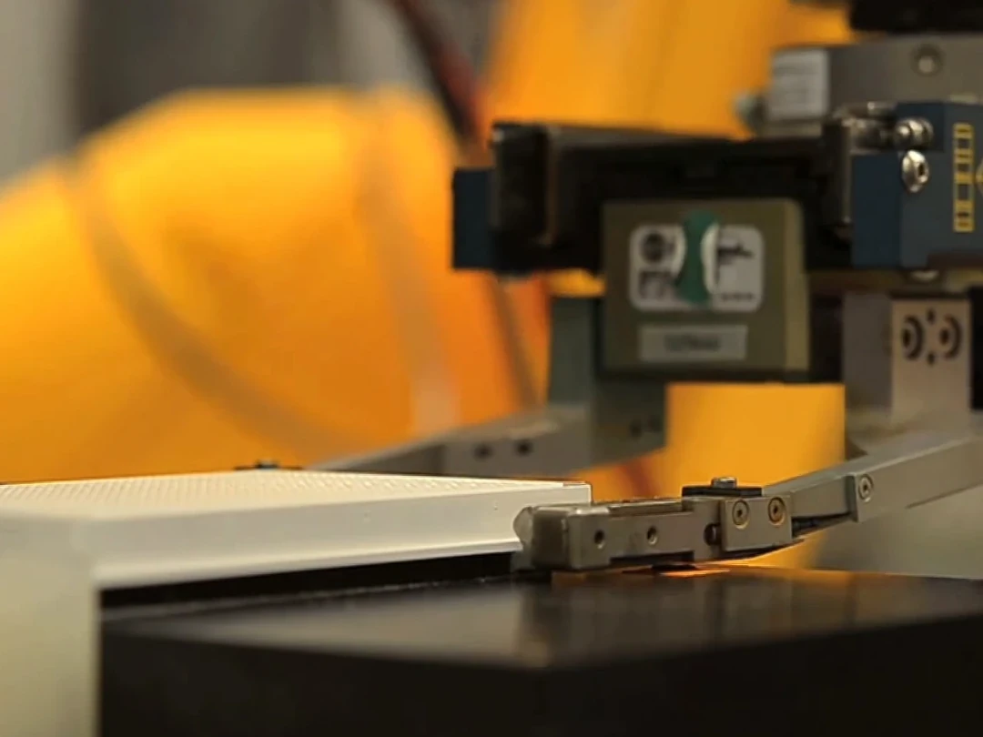 Automated laboratory robot arm handling an assay plate