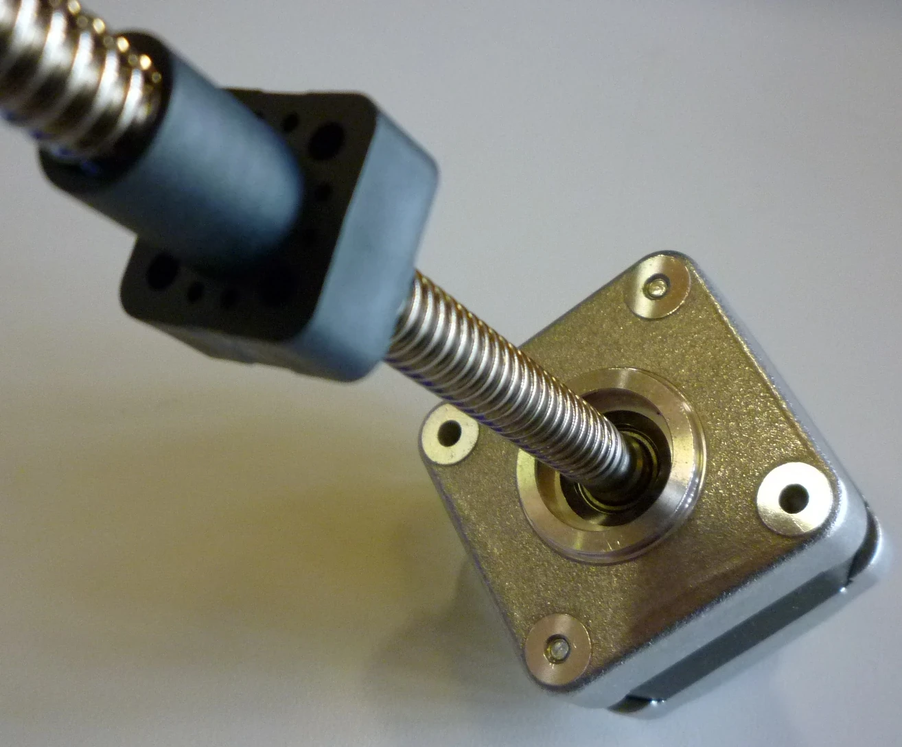 Stepper motor and lead screw converting rotary motion into linear travel