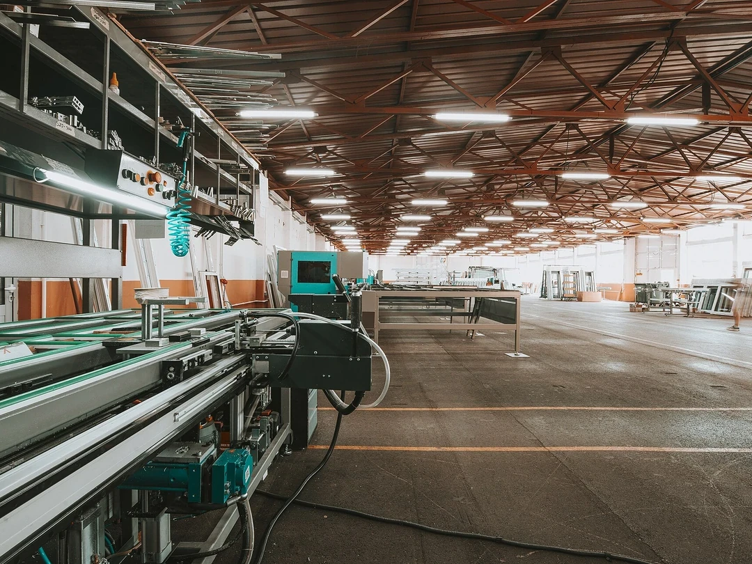 Large modern factory production line with connected industrial equipment and operators